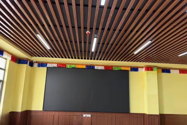 Completed P2 indoor LED display integrated into a traditional wood and textile interior.webp