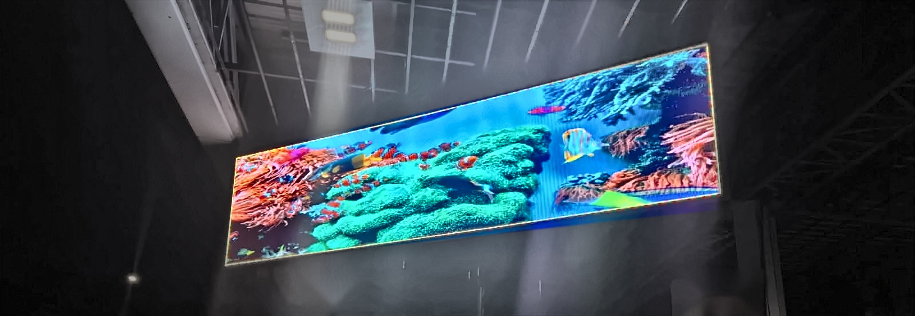 Outdoor LED advertising screen at a gas station canopy