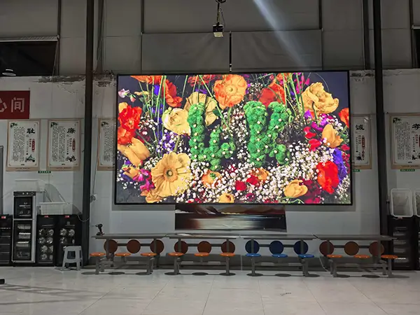 Full view of P2.5 wall-mounted indoor LED screen in a school cafeteria showing vibrant high-definition visuals.webp