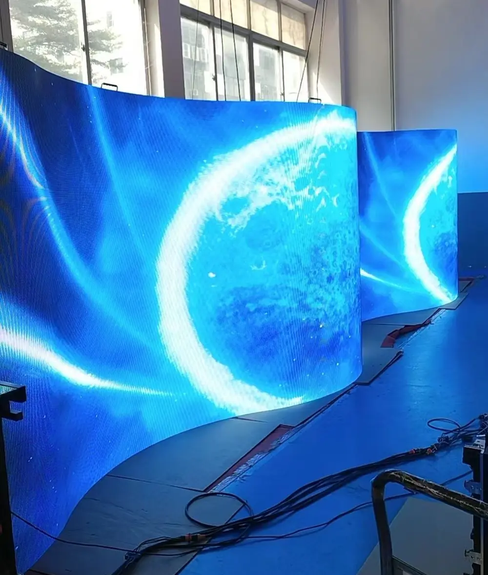Flexible LED display curved into an S-shape during a factory bend test, P1.86 indoor module.webp